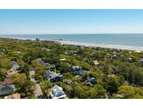 Stunning aerial view of a home near the beach, with lush greenery and ocean views at 409 W Indian Ave, Folly Beach, SC 29439