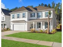 Beautiful two-story home with white siding, shutters, and a manicured green lawn on a sunny day at 606 Dunswell Dr, Summerville, SC 29486