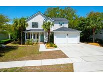 Charming two-story home featuring a well-manicured lawn and an attached two-car garage at 1006 Wayfarer Ln, Charleston, SC 29412