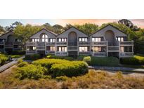Charming beach condos feature balconies and stairs leading to beautiful landscaping with a glimpse of the ocean at 1342 Pelican Watch Villas, Seabrook Island, SC 29455