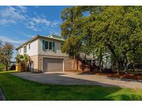 Charming two-story home with a large garage and beautiful mature landscaping at 1392 Eden Rd, Awendaw, SC 29429