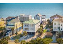 Beautiful beachfront homes with decks overlooking the ocean on a sunny day at 1681 E Ashley Ave # A, Folly Beach, SC 29439