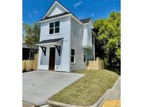 Charming two-story home featuring vertical siding, a gabled roof and a concrete driveway at 1956 Beech Ave, North Charleston, SC 29405