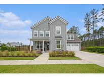 Charming two-story home with gray siding, white trim, and a welcoming front porch and a two-car garage at 200 Clearblue Loop, Summerville, SC 29486