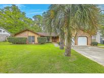 Charming single-story home with lush lawn and mature palm trees at 201 Hunt Club Dr, Summerville, SC 29485