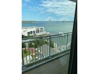 Balcony view overlooking the water, city buildings, and a large bridge in the background at 330 Concord St # 15C, Charleston, SC 29401