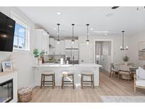 Bright, modern kitchen with white cabinetry, stainless steel appliances, and a breakfast bar with seating at 333 Bremerton Dr, Goose Creek, SC 29445