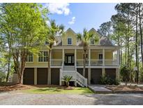 Charming coastal home with a spacious porch, landscaped yard, and inviting staircase at 478 Commonwealth Rd, Mount Pleasant, SC 29466