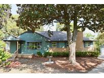 Charming home with a brick and siding exterior and a mature tree in the front yard at 5452 E Lakeland Dr, North Charleston, SC 29406