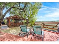 Relaxing back deck featuring a screened gazebo, marsh view and two chairs at 5703 St Angela Dr, North Charleston, SC 29418