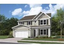 Charming two-story home with a symmetrical facade, manicured lawn, and attached two-car garage for modern convenience at 739 Maynard Ln, Summerville, SC 29486