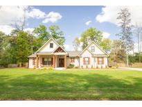 Charming single-story home with a beautifully landscaped front yard and inviting front porch with craftsman style columns at 74 Longleaf Dr, Walterboro, SC 29488
