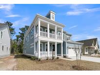 Charming two-story home featuring a double porch, craftsman details, and attached two-car garage at 757 Maynard Ln, Summerville, SC 29486