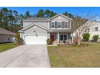 Charming two-story home features gray siding, black shutters, a white garage door, and a well-maintained front lawn at 1019 Victoria Pointe Ln, Summerville, SC 29485