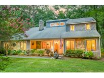 Charming two-story home featuring stone accents, mature landscaping, and a welcoming front porch at 111 Garden Hill Rd, Summerville, SC 29483