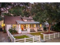 Charming single story traditional-style home with white picket fence, beautiful lawn, and manicured landscaping at 1454 Seminole St, Mount Pleasant, SC 29464