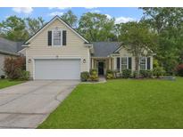 Charming single-Gathering home with a well-manicured lawn and attached two-car garage at 1726 Waterbrook Dr, Charleston, SC 29414