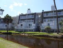Waterfront condo building featuring multiple decks and pleasant surroundings at 237 Driftwood Ln, Edisto Island, SC 29438