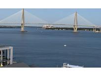 Enjoy the breathtaking water views from this stunning property, with a boat sailing under the Ravenel Bridge at 330 Concord St # 15B, Charleston, SC 29401