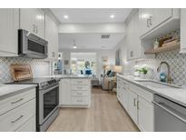 Bright kitchen featuring white cabinets, stainless steel appliances, and stylish backsplash tile at 3372 Billings St, Mount Pleasant, SC 29466
