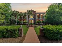 Stately two-story home with a beautiful front yard, lush landscaping, and a grand entrance at 421 Royal Assembly Dr, Charleston, SC 29492