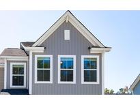 New construction gray home featuring white trim, and a board and batten gable at 825 Alma Square Dr, Moncks Corner, SC 29461