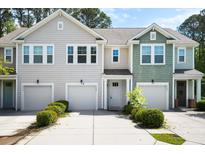 Charming townhomes featuring attached garages, manicured landscaping and craftsman-style details at 9428 Sweep Dr, Summerville, SC 29485