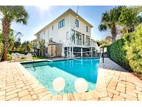 Inviting backyard pool with clear water, lounge chairs and well manicured yard at this home at 109 Carolina Blvd, Isle of Palms, SC 29451