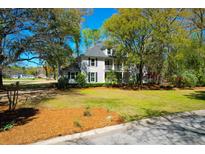 Charming two-story home with landscaped yard, mature trees, and a welcoming front porch at 12 Trail Hollow Ct, Charleston, SC 29414