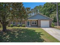 Charming brick home features a well-manicured lawn and inviting front entrance at 122 William St, Summerville, SC 29486
