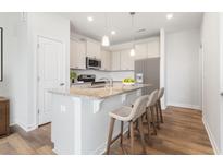 Charming kitchen with granite countertops, island with seating, and stainless steel appliances at 125 O'Malley Dr, Summerville, SC 29483