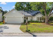 Charming one story home with solar panels, attached garage, manicured lawn and front garden at 1379 Downsberry Dr, Mount Pleasant, SC 29466