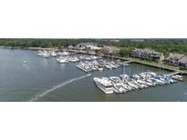 A picturesque aerial view showcases the marina with numerous boats docked in the calm waters at 1880 Andell Bluff Blvd # Slip E 9, Johns Island, SC 29455