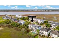 Beautiful home on the water with a pool in the backyard and gorgeous landscaping at 3107 S Shore Dr, Charleston, SC 29407