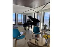 Bright living room featuring a grand piano and water views at 330 Concord St # 12 F&G, Charleston, SC 29401