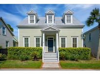 Charming two-story home with a well-manicured lawn and beautiful landscaping at 41 Jane Jacobs St, Mount Pleasant, SC 29464