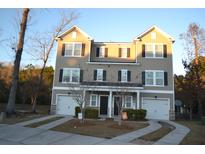 Charming townhome with symmetrical facade, individual garages, and inviting driveways at 4210 Scharite St, Charleston, SC 29414