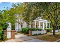 Charming exterior showcasing a white home with a welcoming front porch and picket fence at 43 Montrose Rd, Mount Pleasant, SC 29464