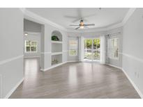 Bright living room with hardwood floors and a sliding glass door to the outside patio at 1300 Park West Blvd # 101, Mount Pleasant, SC 29466