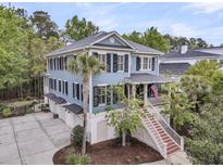 Charming multi-story home boasting a welcoming porch, well-manicured landscaping, and ample parking at 1531 Capel St, Mount Pleasant, SC 29466