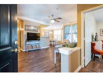 Inviting living room featuring hardwood floors, a ceiling fan, and comfortable seating near large windows at 1615 Chatelain Way, Mount Pleasant, SC 29464