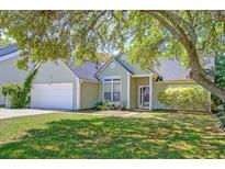 Charming single-story home featuring a well-manicured lawn and attached two car garage at 208 Evesham Dr, Summerville, SC 29485