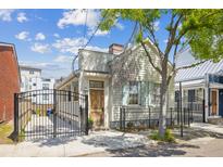 Charming exterior view of a home featuring a gated entrance and inviting curb appeal at 22 Sheppard St, Charleston, SC 29403