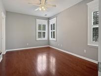 Bright bedroom features hardwood floors, modern ceiling fan, and white-trimmed windows at 304 Pimpernel St, Summerville, SC 29483