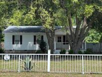 Quaint single story home with white siding and a charming white picket fence at 3342 Habitat Blvd Blvd, Johns Island, SC 29455