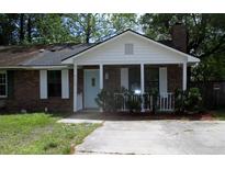 Charming one-story brick home with a cozy front porch and a well-maintained lawn at 4153 Hickory Ln, Ladson, SC 29456