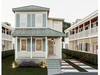 Charming two-story home featuring a welcoming front porch and beautifully landscaped front yard at 8 Homel Pl, Charleston, SC 29403