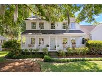 Charming two-story home with a welcoming front porch and beautifully landscaped front yard at 99 Shadowmoss Pkwy, Charleston, SC 29414