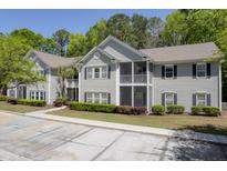 Charming two-story condo complex with gray siding, black shutters, and screened in porches at 106 Pickering Ln, Charleston, SC 29414