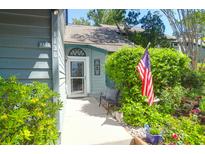 Charming home entrance featuring a decorative door, lush greenery, and a welcoming American flag, offering curb appeal at 1136 Shadow Lake Cir # 54, Mount Pleasant, SC 29464